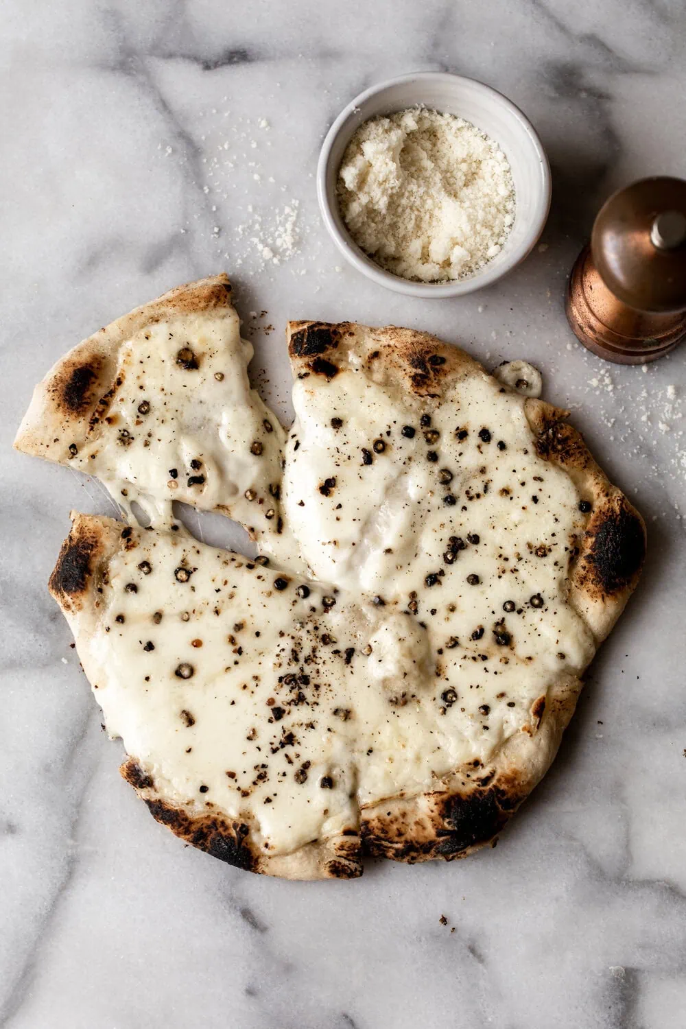 cacio e pepe pizza with cheese and black pepper