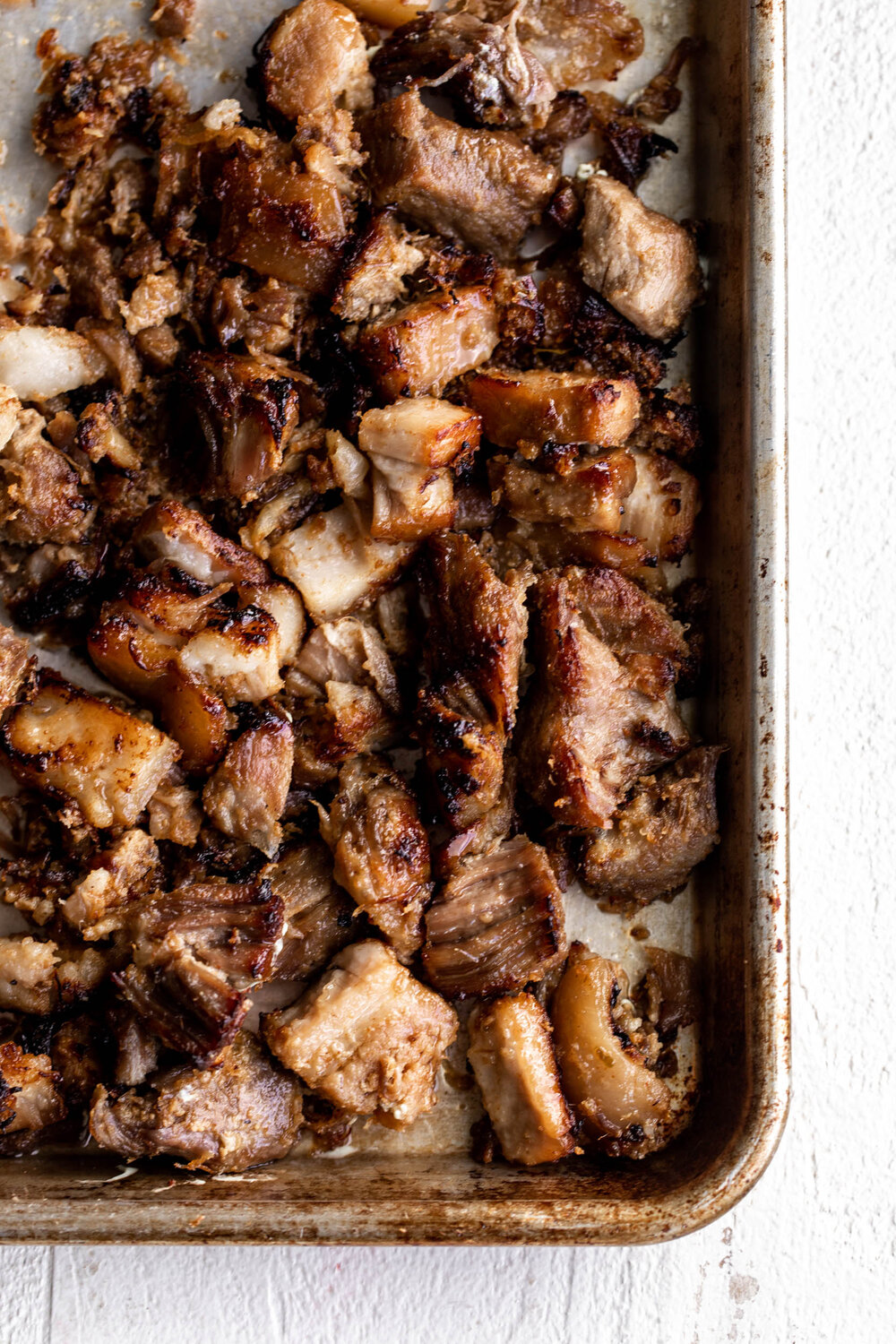 crispy pork carnitas on baking sheet