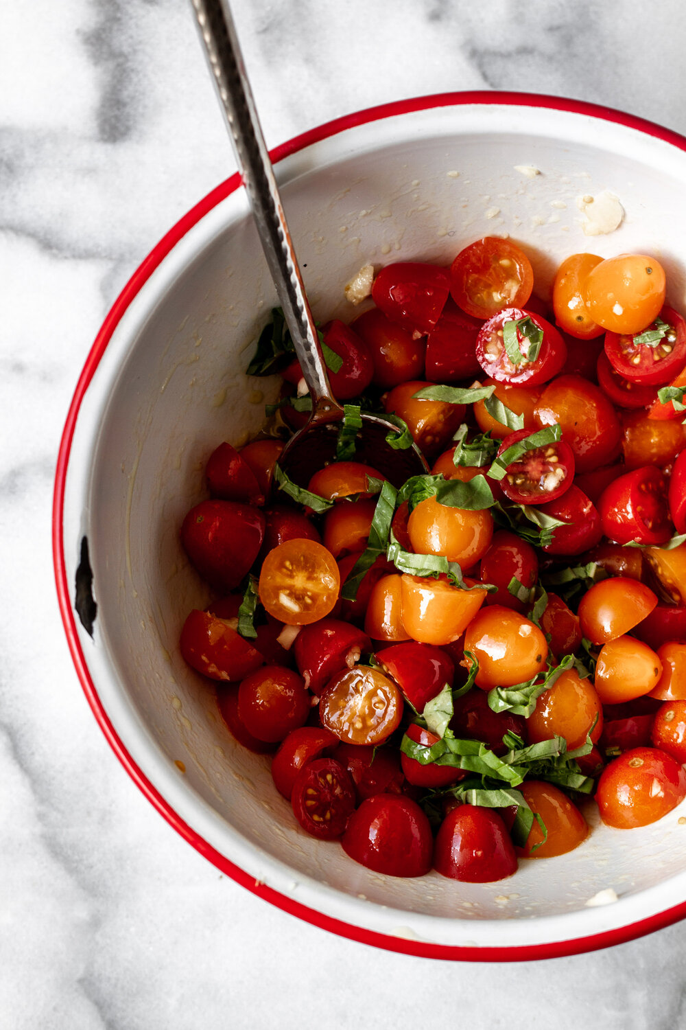 halved cherry tomatoes with olive oil garlic and chopped basil 