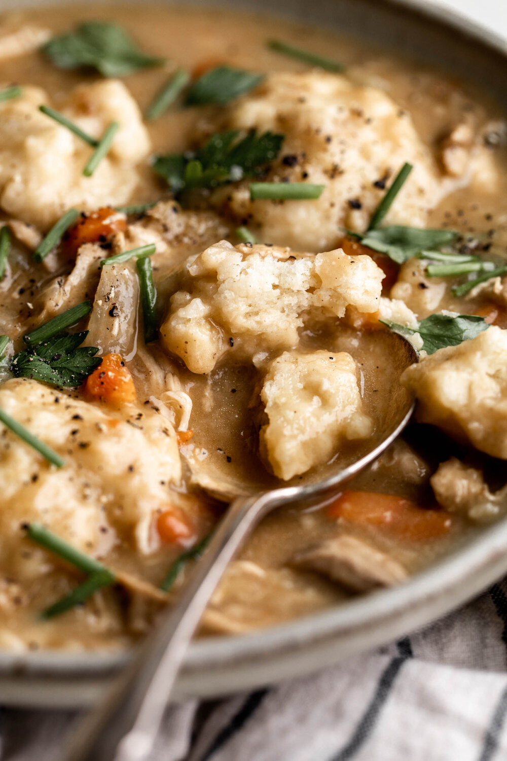 Chicken and Dumpling Soup split open dumpling with spoon