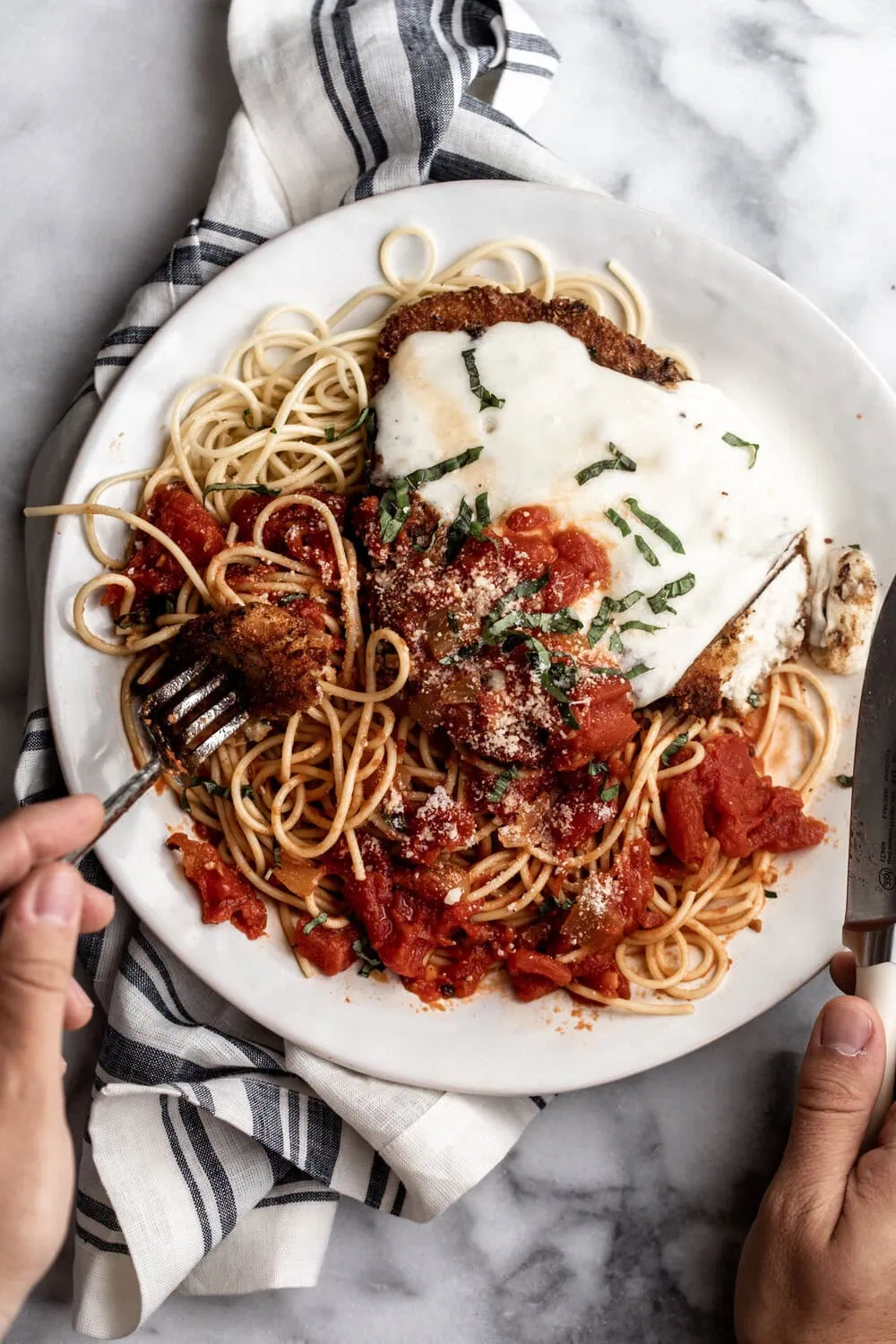 Chicken Parmesan with Marinara Sauce and melted mozzarella cheese over spaghetti