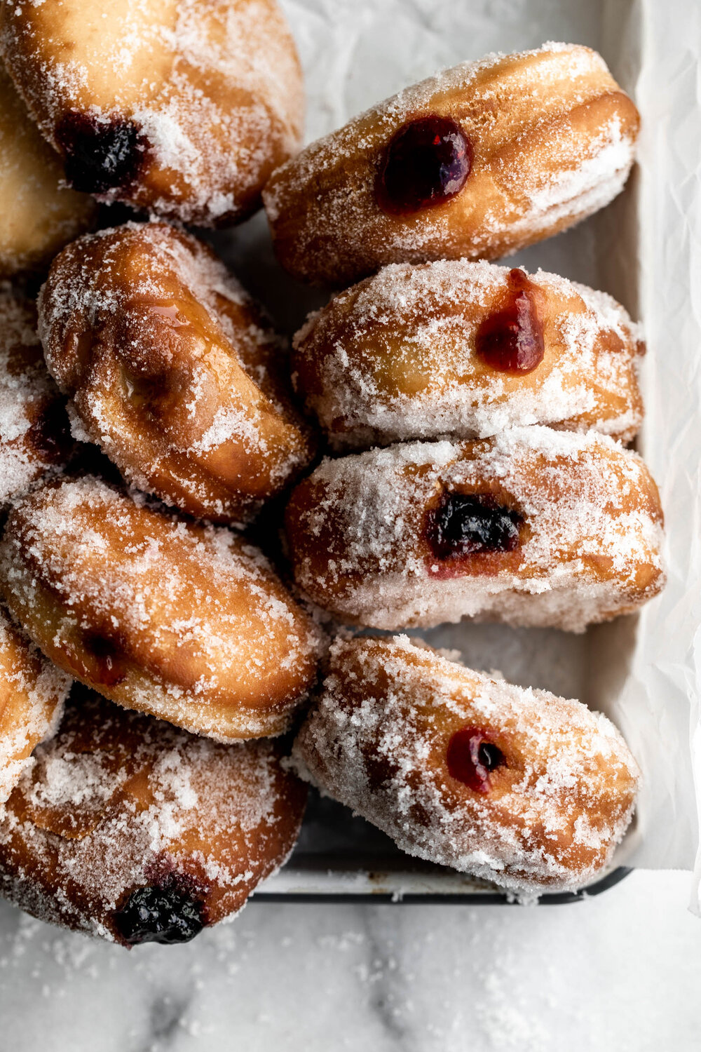 Make your favorite jelly doughnuts at home. Sweet yeast doughnut dough fried and filled with your favorite jelly and jams. 