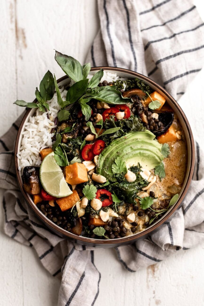 vegan Coconut curry roasted sweet potato lentil bowl with black lentils, mushrooms, kale, sweet potato over a bed of jasmine rice.