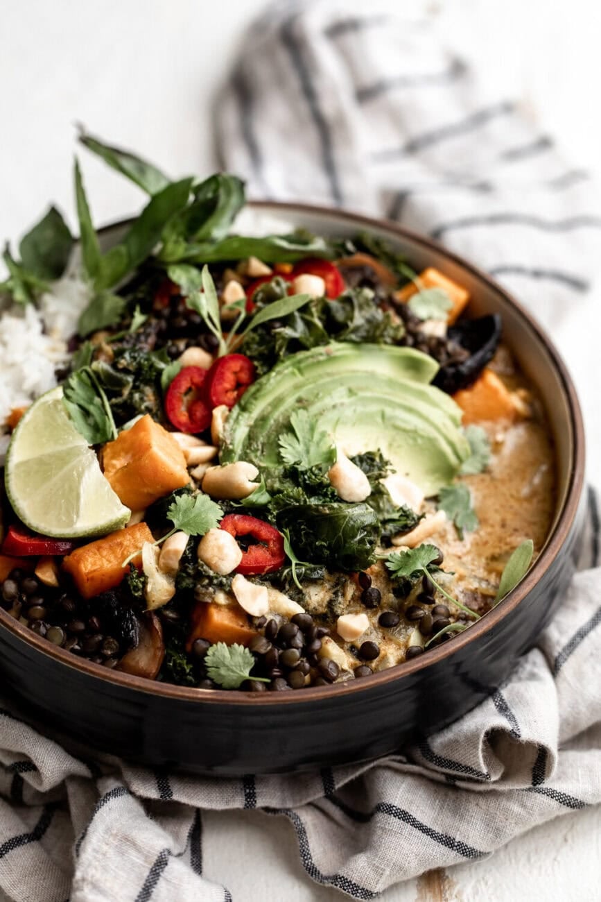 Coconut curry roasted sweet potato lentil bowl with lentils, mushrooms, kale, sweet potato over rice.