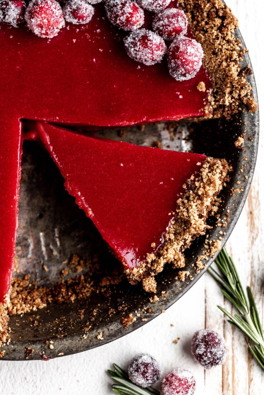 slice of cranberry ginger pie in pie dish.