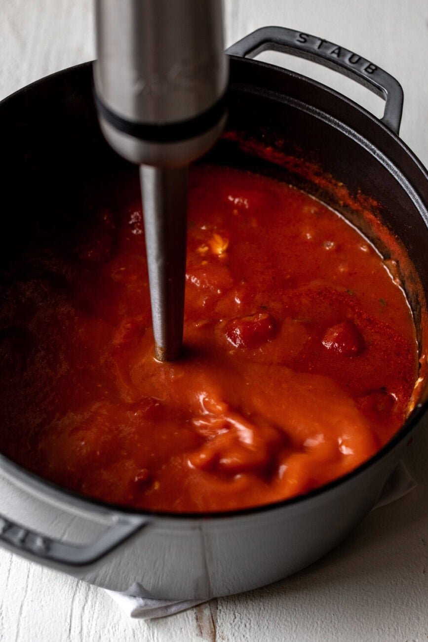 blended tomato soup in pot with immersion blender.