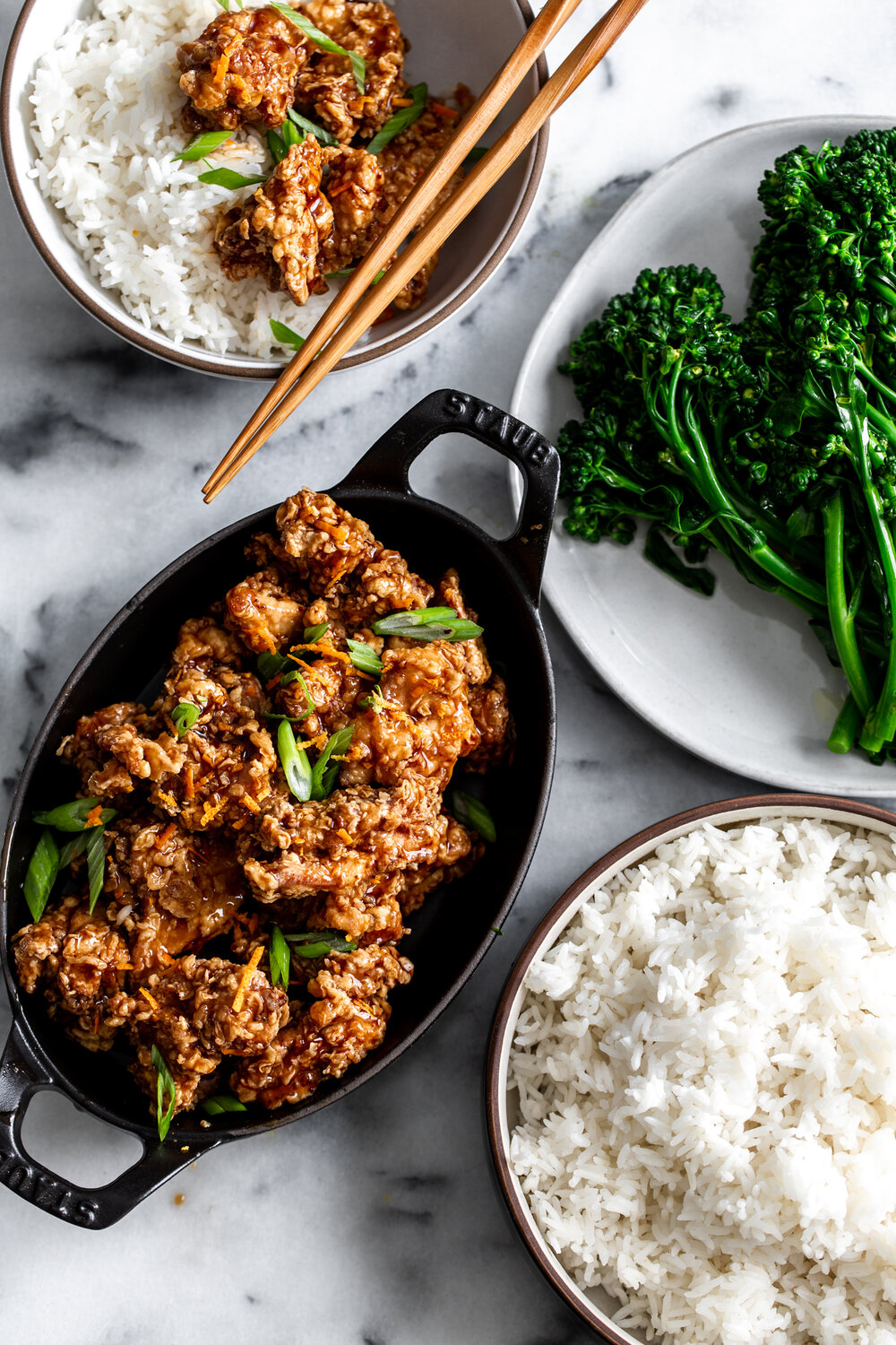 Crispy Orange Chicken in baking dish with roasted broccolini and white rice