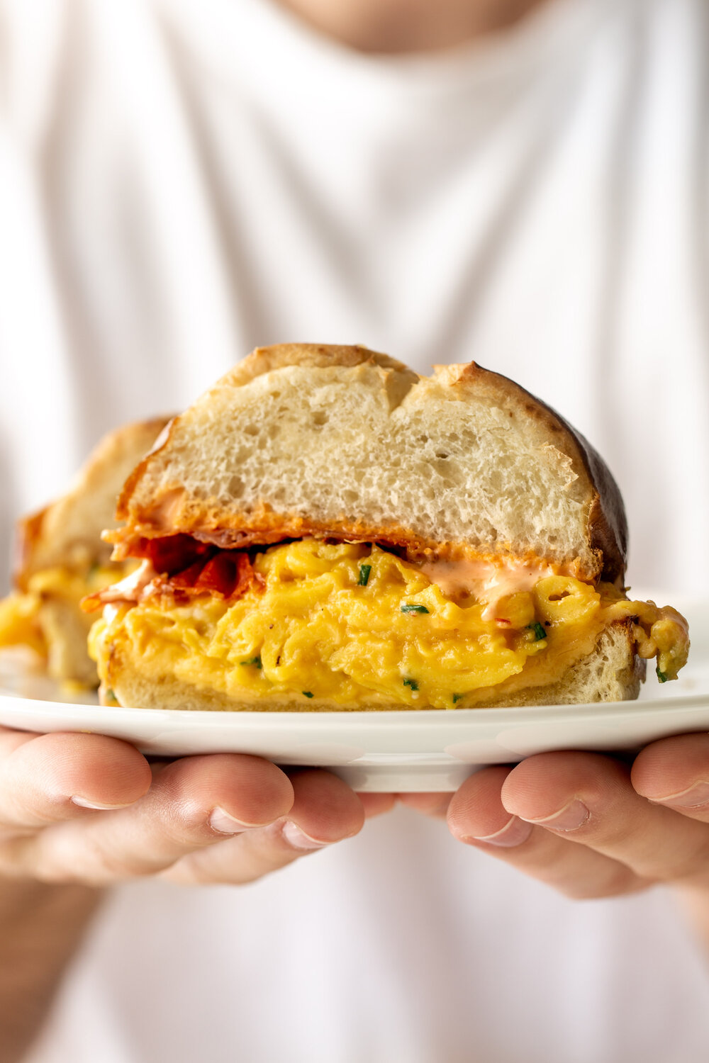 Egg, Cheese & Crispy Prosciutto Breakfast Sandwich on a Pretzel Bun halved