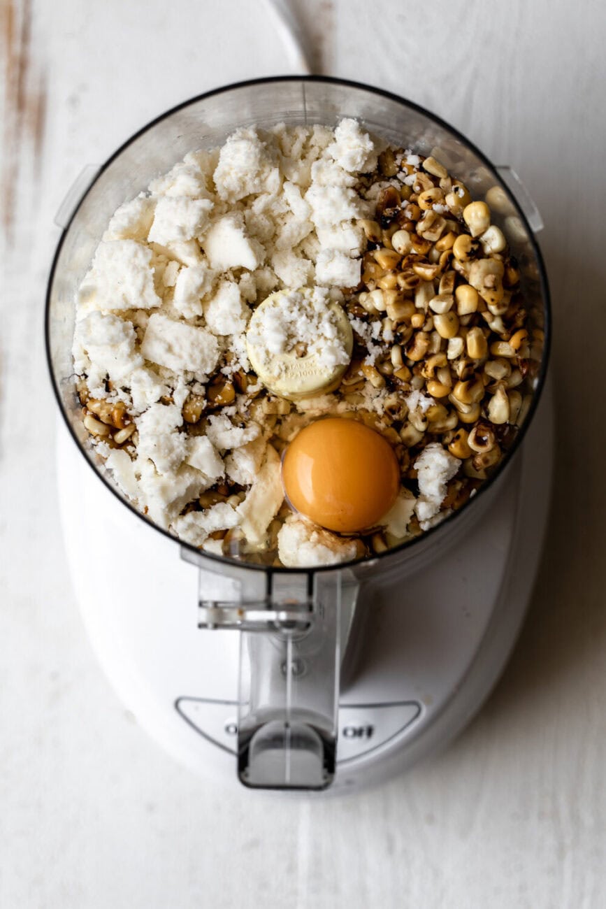 cotija cheese with roasted corn and egg in food processor.