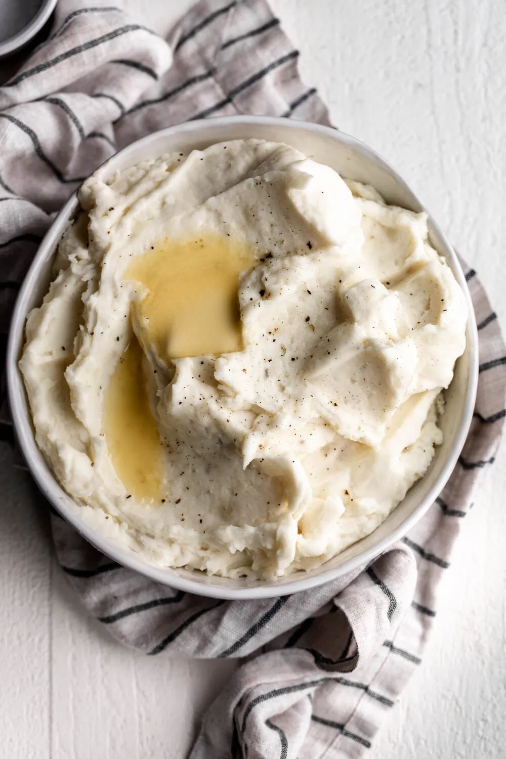 Garlic Mashed Potatoes with pats of butter melting