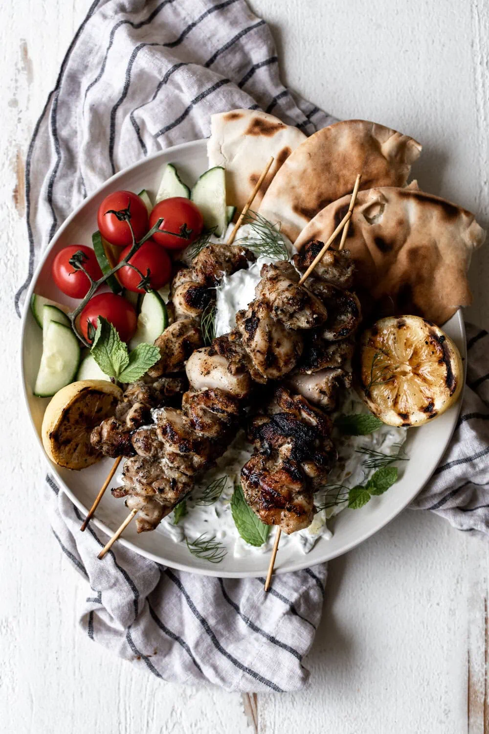Greek chicken souvlaki with pita and charred lemon