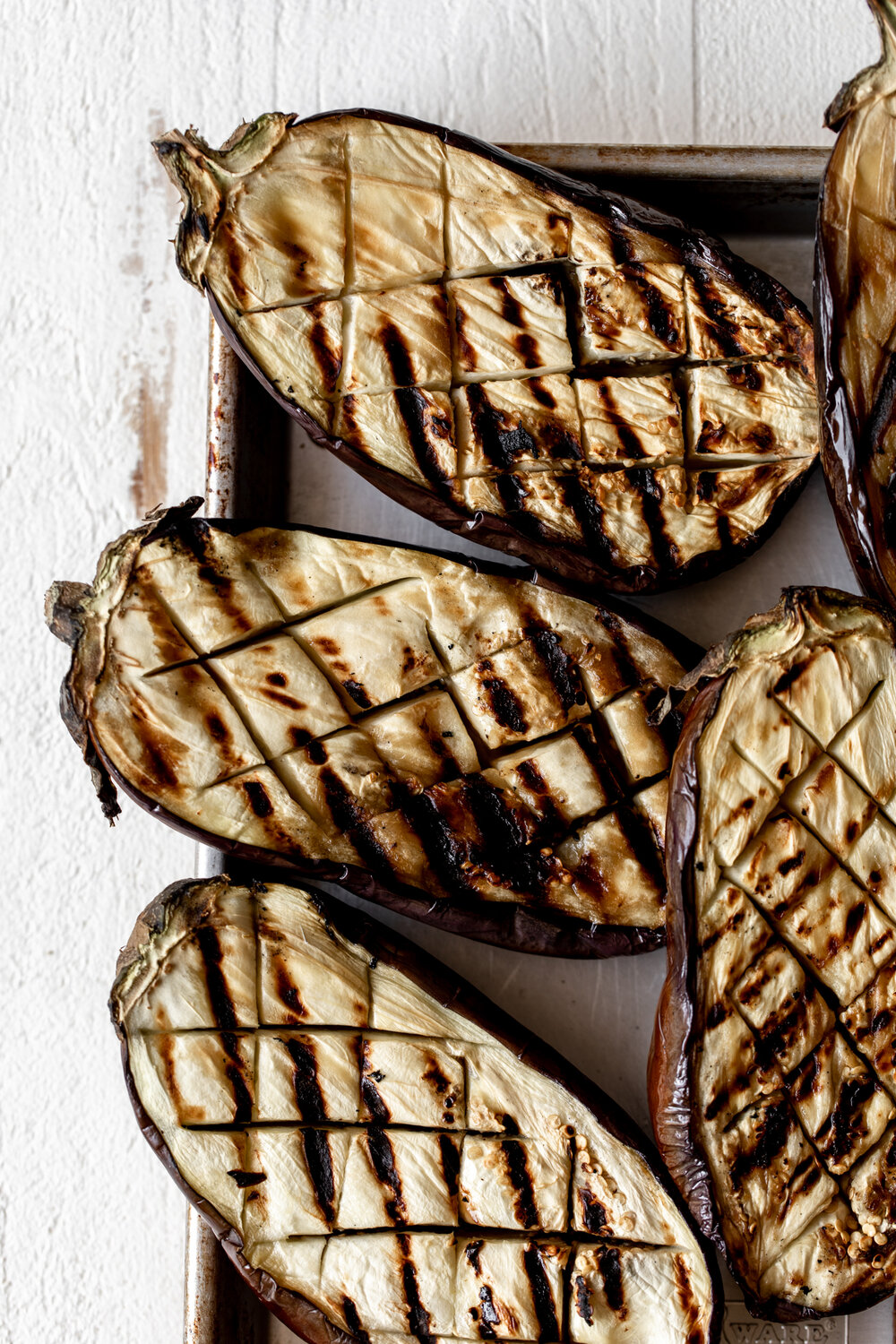 grilled eggplants on baking sheet