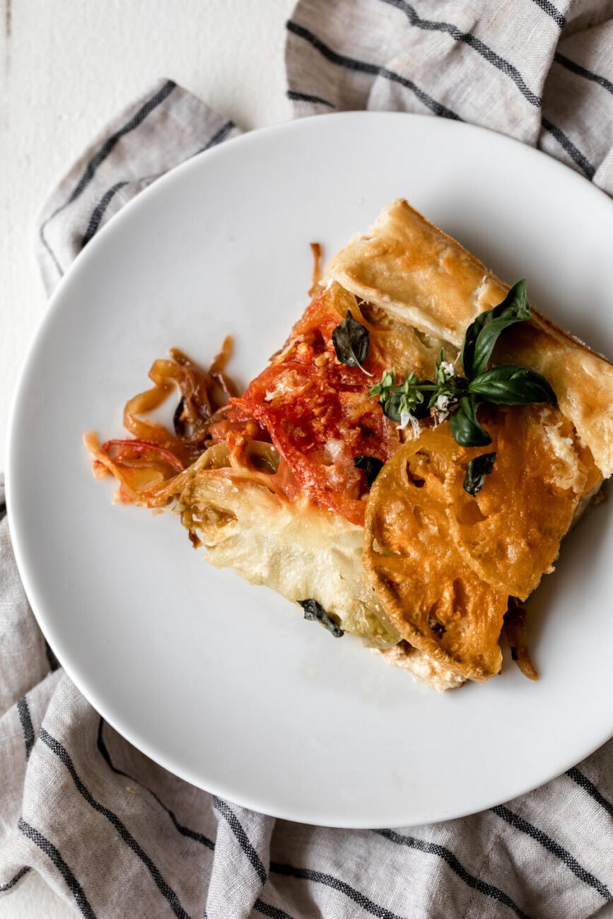 tomato galette recipe summer heirloom tomatoes, caramelized onions and ricotta cheese wrapped in pastry dough.