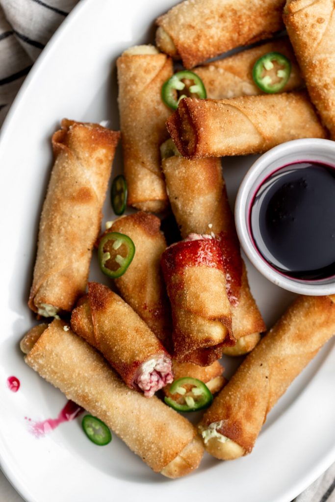 jalapeño egg rolls with huckleberry syrup in small bowl
