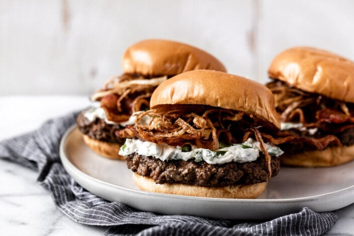 Jalapeño popper burgers topped with crispy fried onions and jalapeño cream cheese.