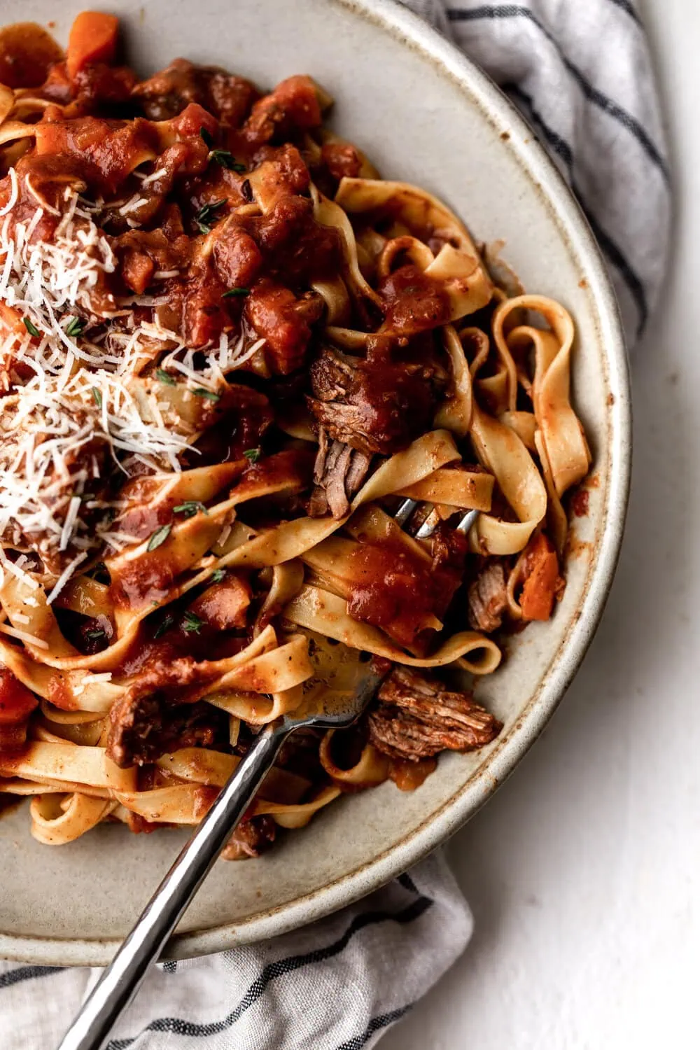 Lamb Ragu over tagliatelle topped with grated parmesan cheese