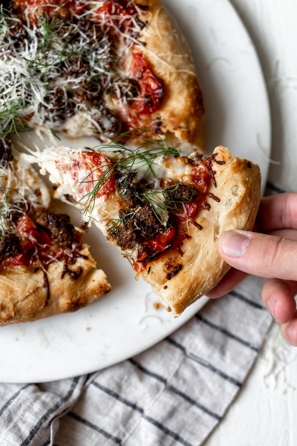 Lamb Sausage Pizza with Confit Tomatoes and Fennel slice