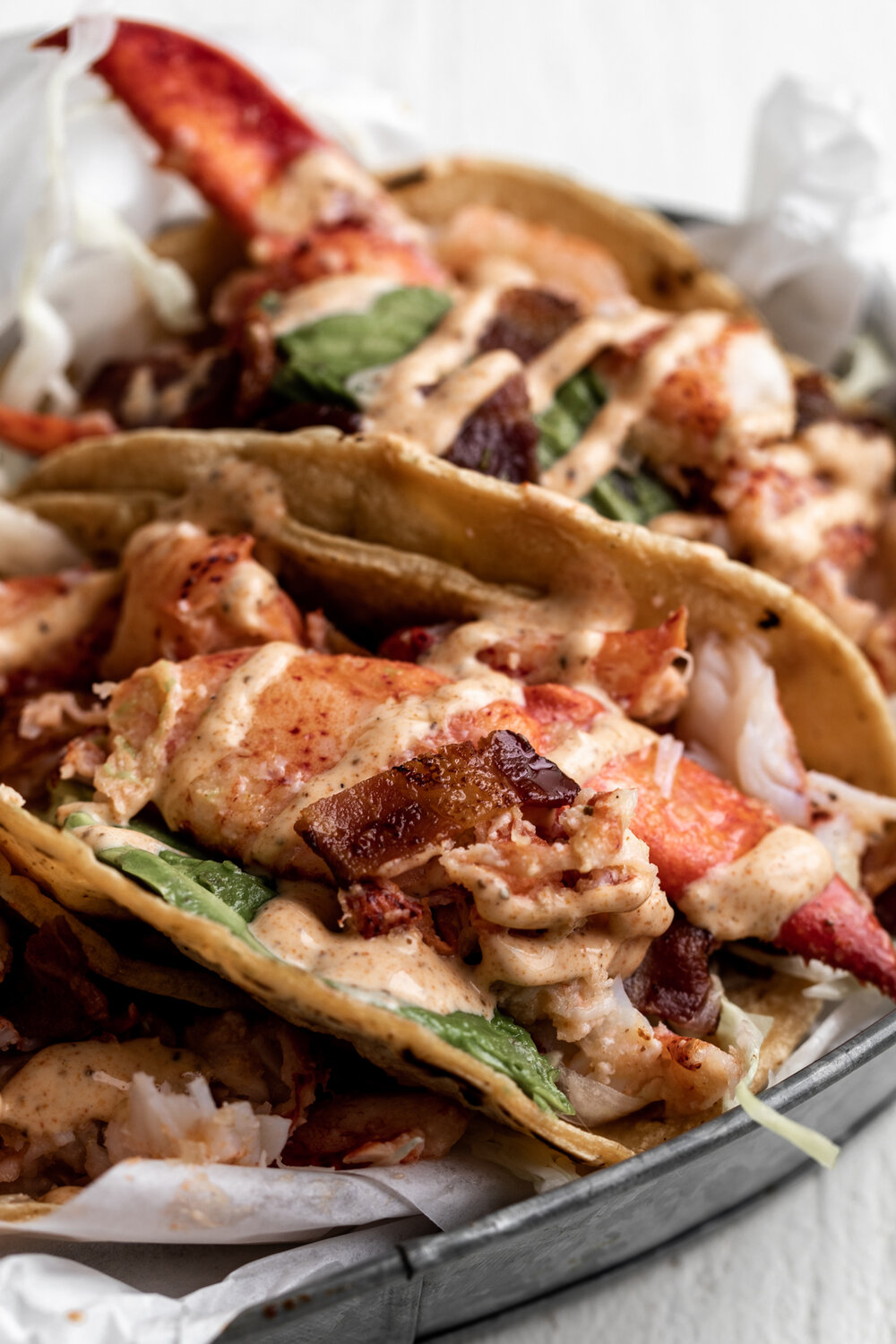 Lobster & Bacon Tacos with Old Bay Crema ws ith avocado slice