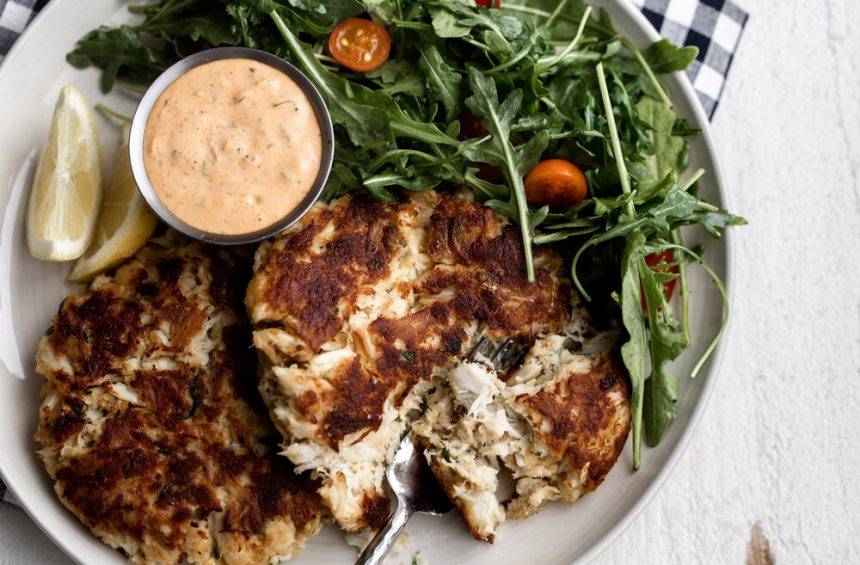 Maryland Style Crab Cakes recipe paired with remoulade sauce and arugula salad.
