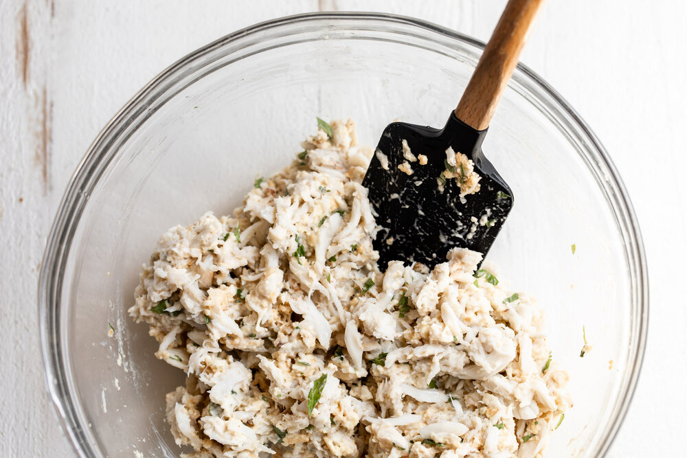 Maryland Style Crab Cakes mixture in mixing bowl with spatula