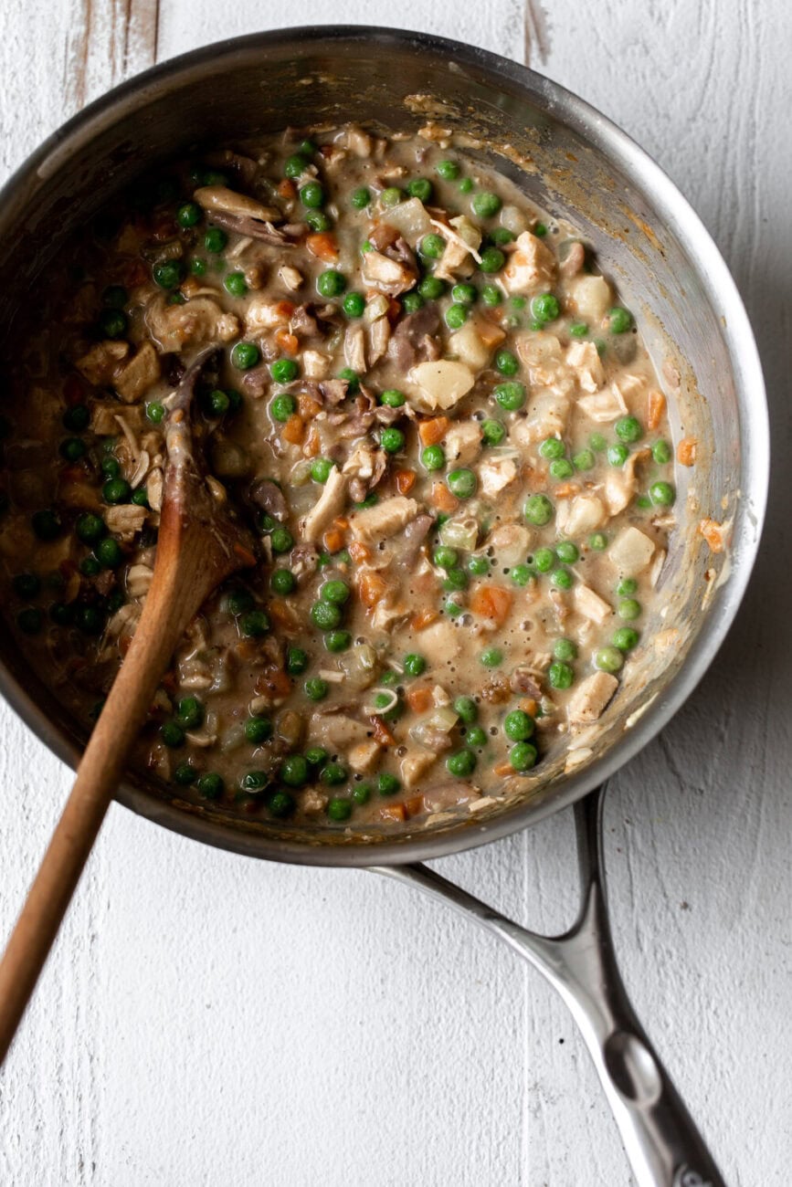 Mini Chicken Pot pie with prosciutto filling in pot.