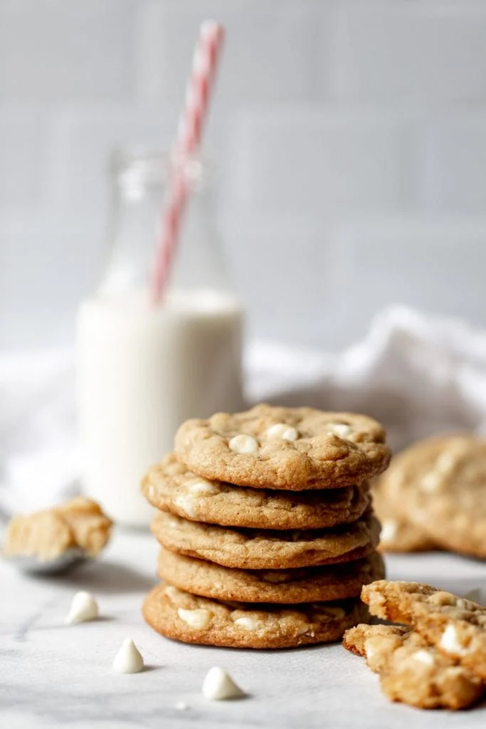 Miso Brown Butter Cookies with White Chocolate Chips stacked with milk christmas cookies