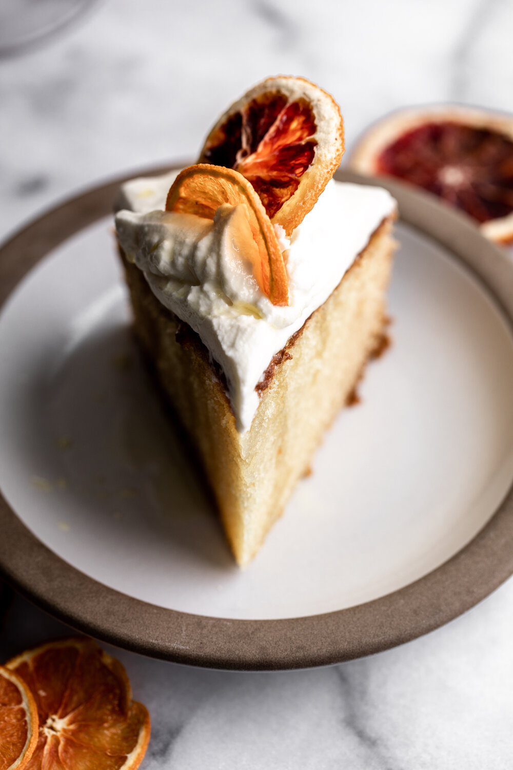 orange olive oil cake with mascarpone whipped cream and dried citrus slices