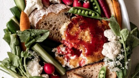 Crispy fried goat cheese with hot raspberry honey with bread and crudité.
