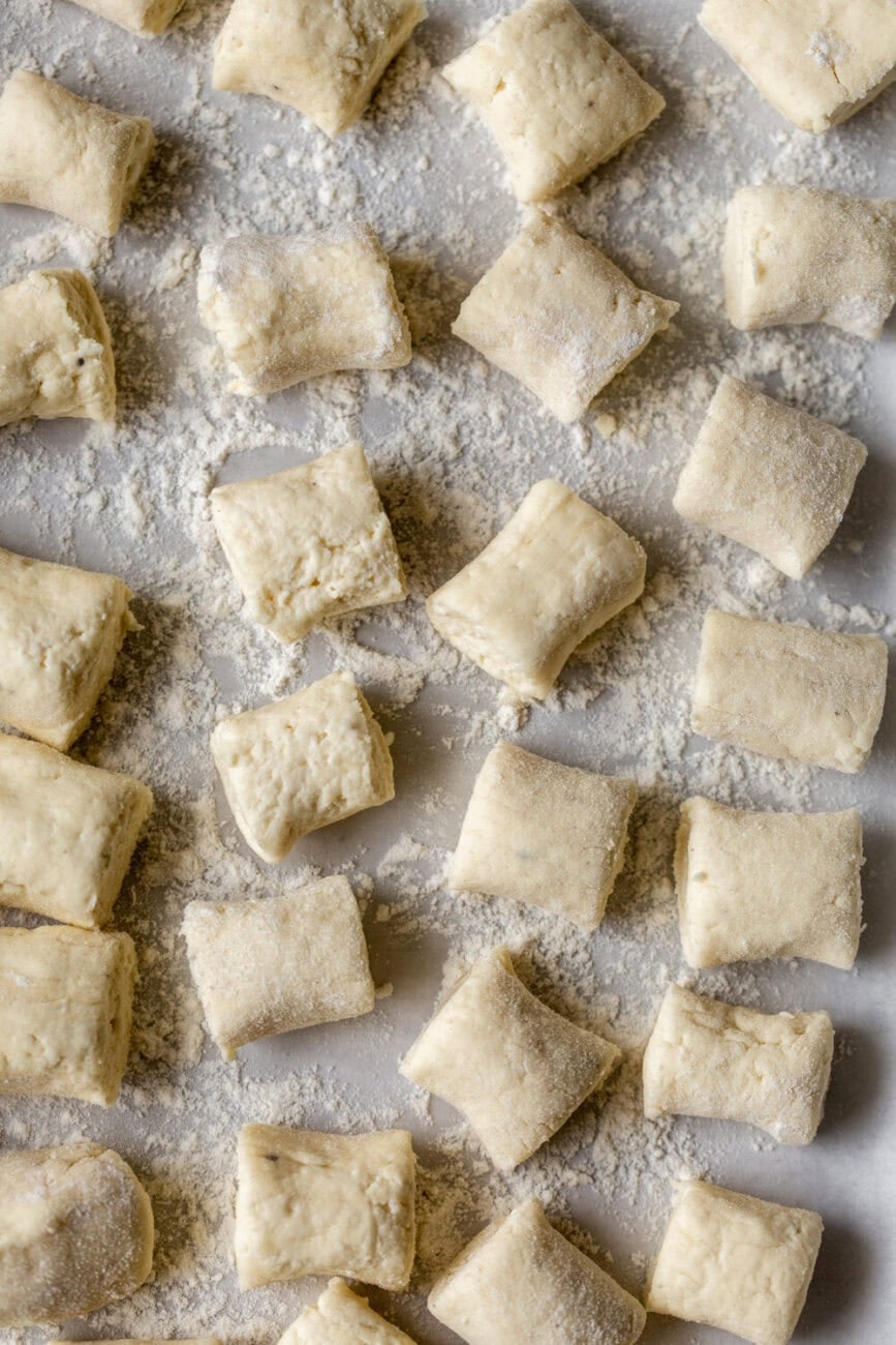 cut ricotta gnocchi cut into pieces tossed in flour on baking sheet.