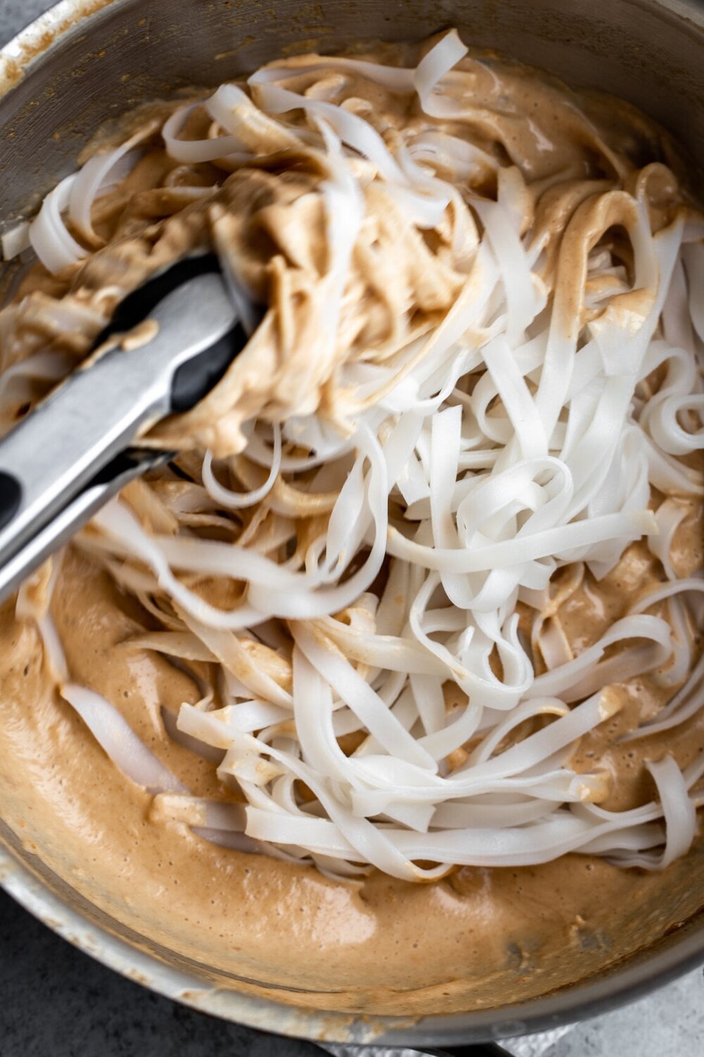 rice noodles tossed in peanut sauce