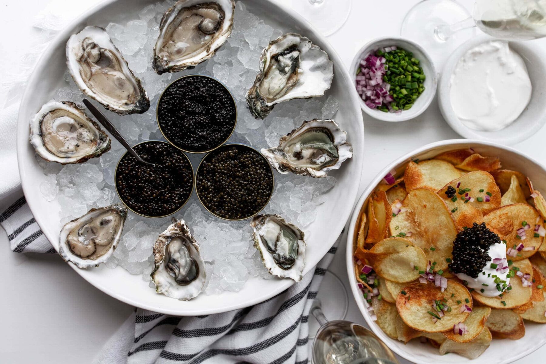 raw oysters on the half shell with caviar and chips.