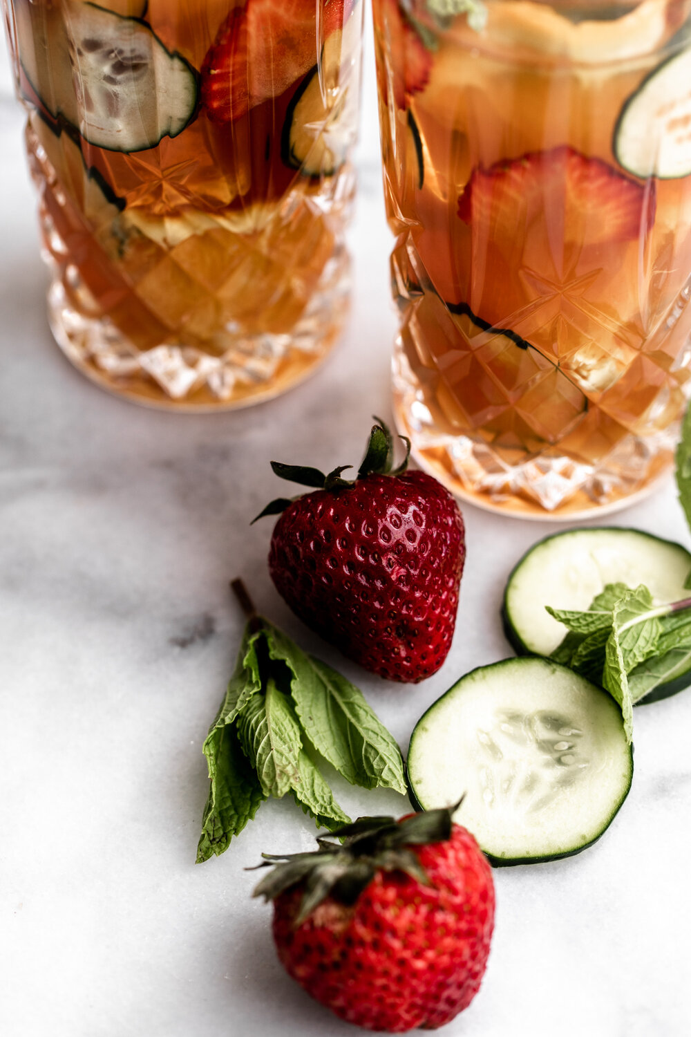 sliced cucumber mint and strawberries