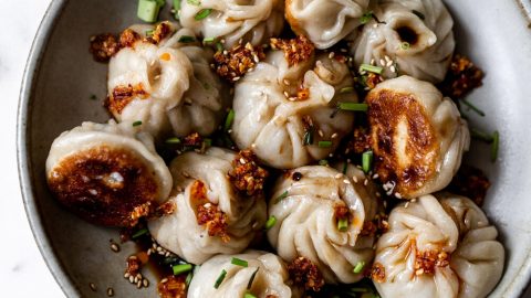 homemade chinese-inspired pork and chive filled top twisted dumpling pan-fried