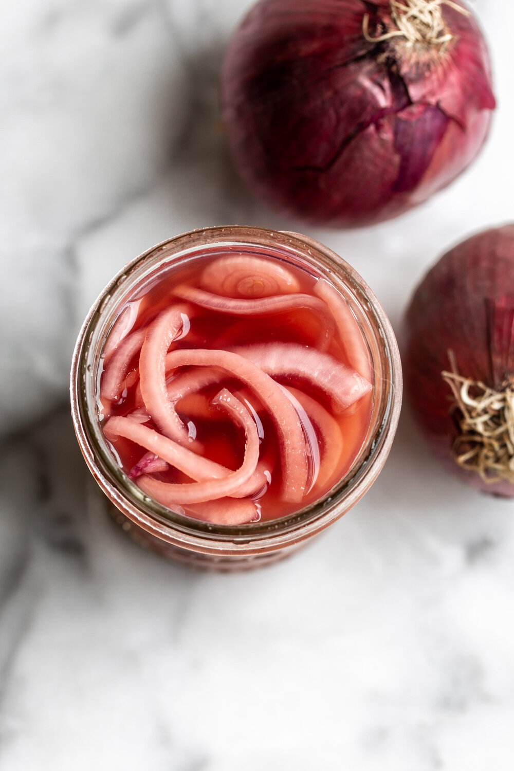 This quick pickled red onion recipe comes together with just a few simple ingredients. Make in advance and use for a tangy condiment. 