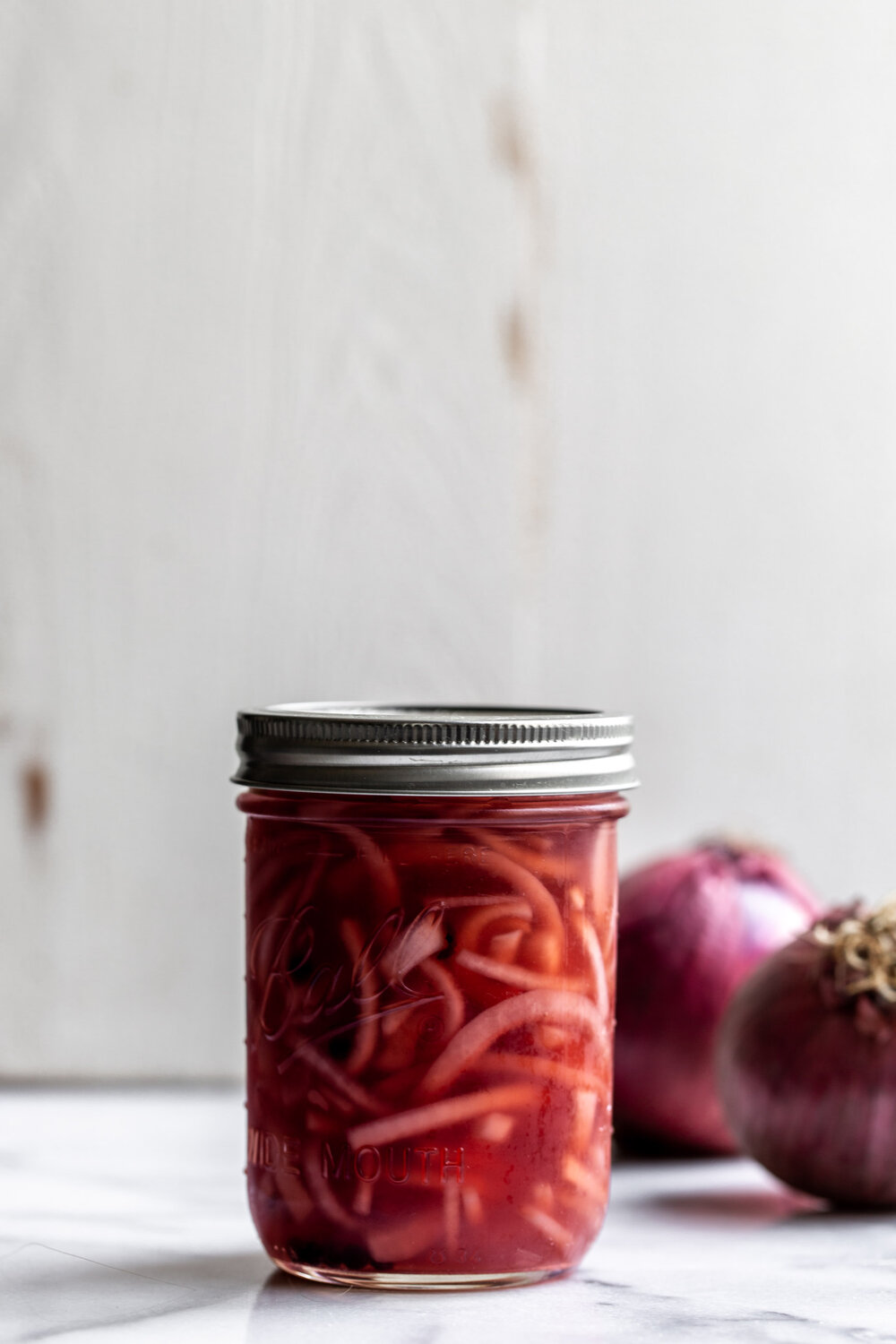 This quick pickled red onion recipe comes together with just a few simple ingredients. Make in advance and use for a tangy condiment. 