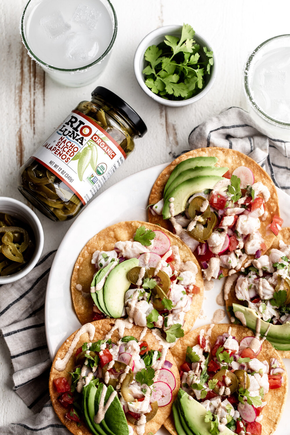 Rio Luna Baja Fish Tostada on plate with margarita glasses