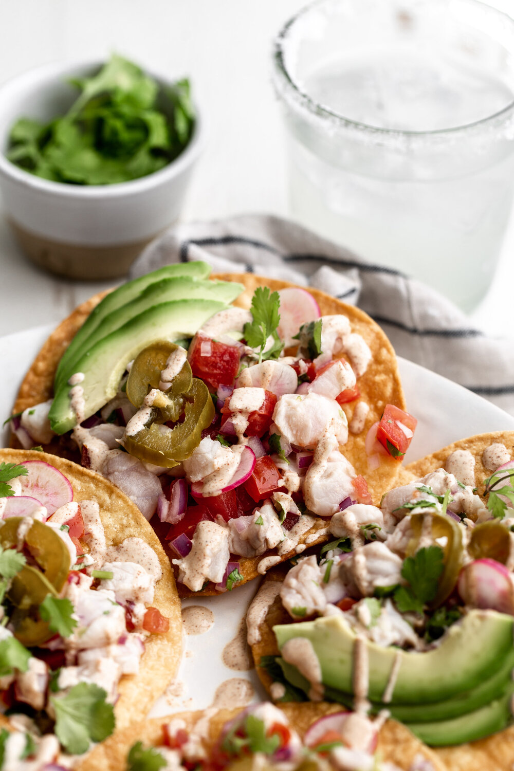 white fish ceviche tostada with jalapeño and avocado