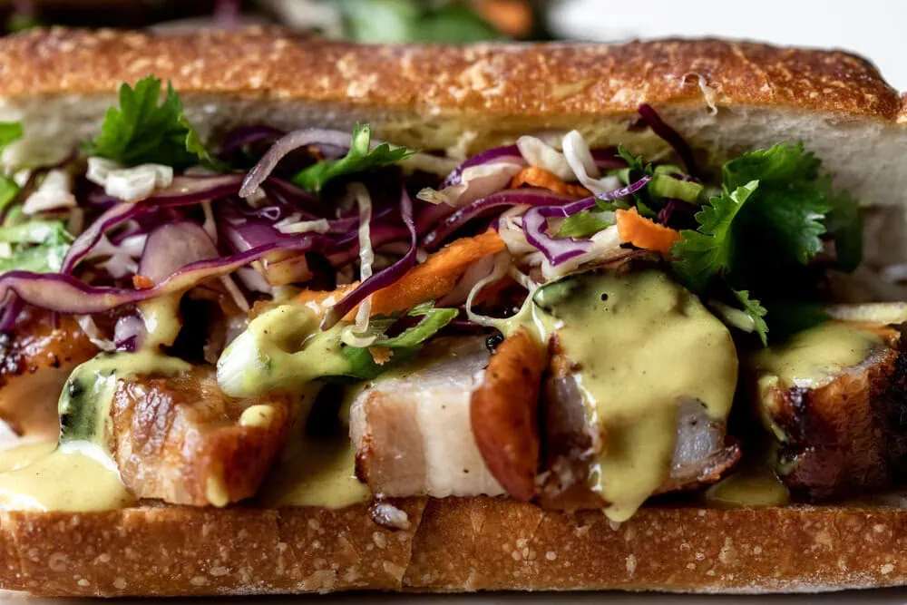 Roast Pork Belly Sandwich with Yellow Coconut Curry Sauce & Thai Slaw