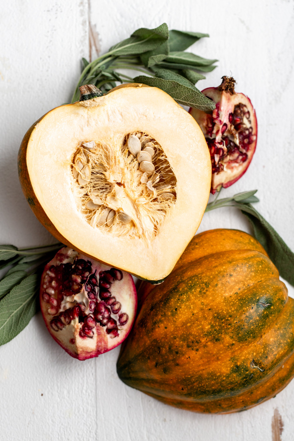 acorn squash with pomegranate and sage leaves
