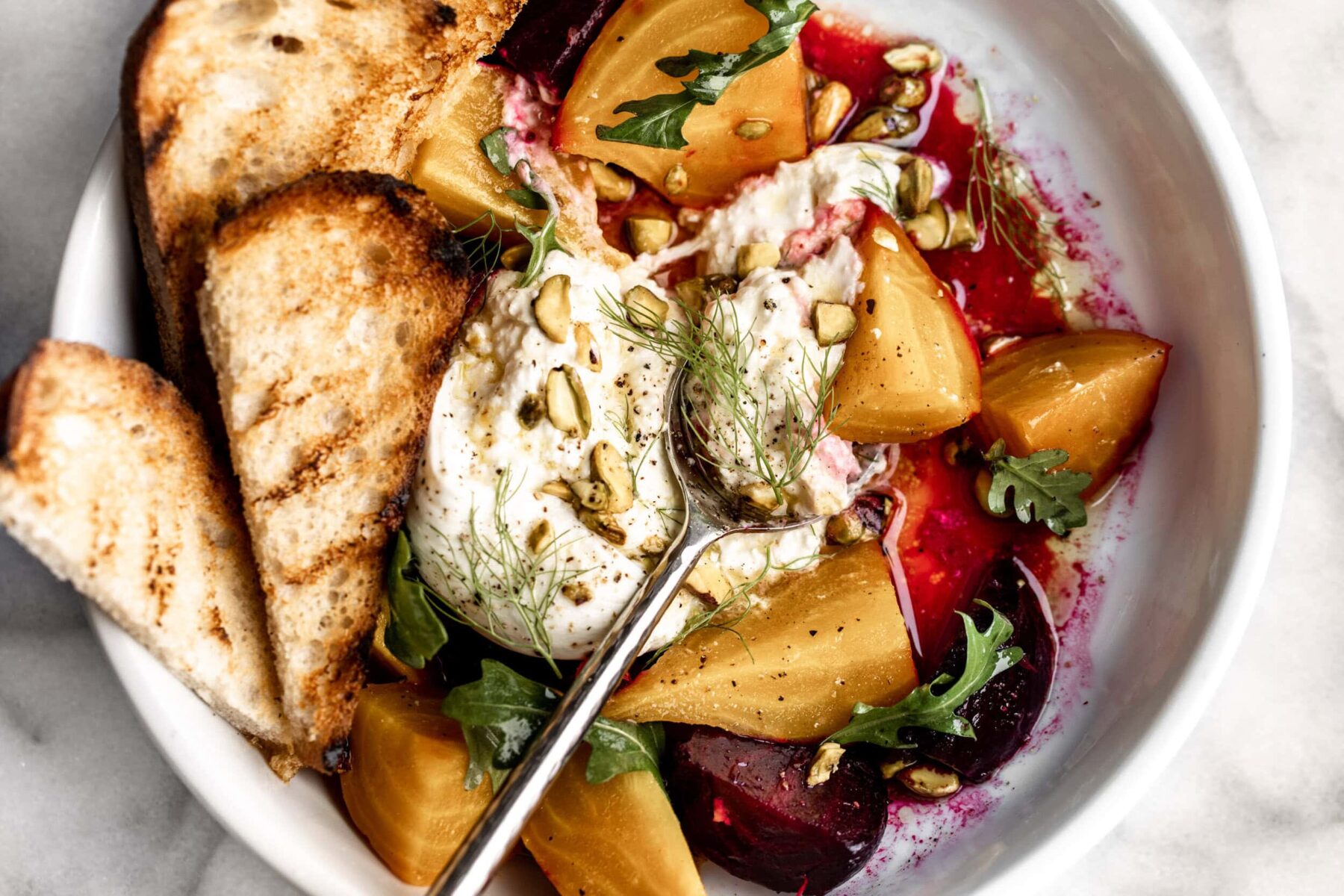 roasted beet salad with burrata cheese and pistachios.
