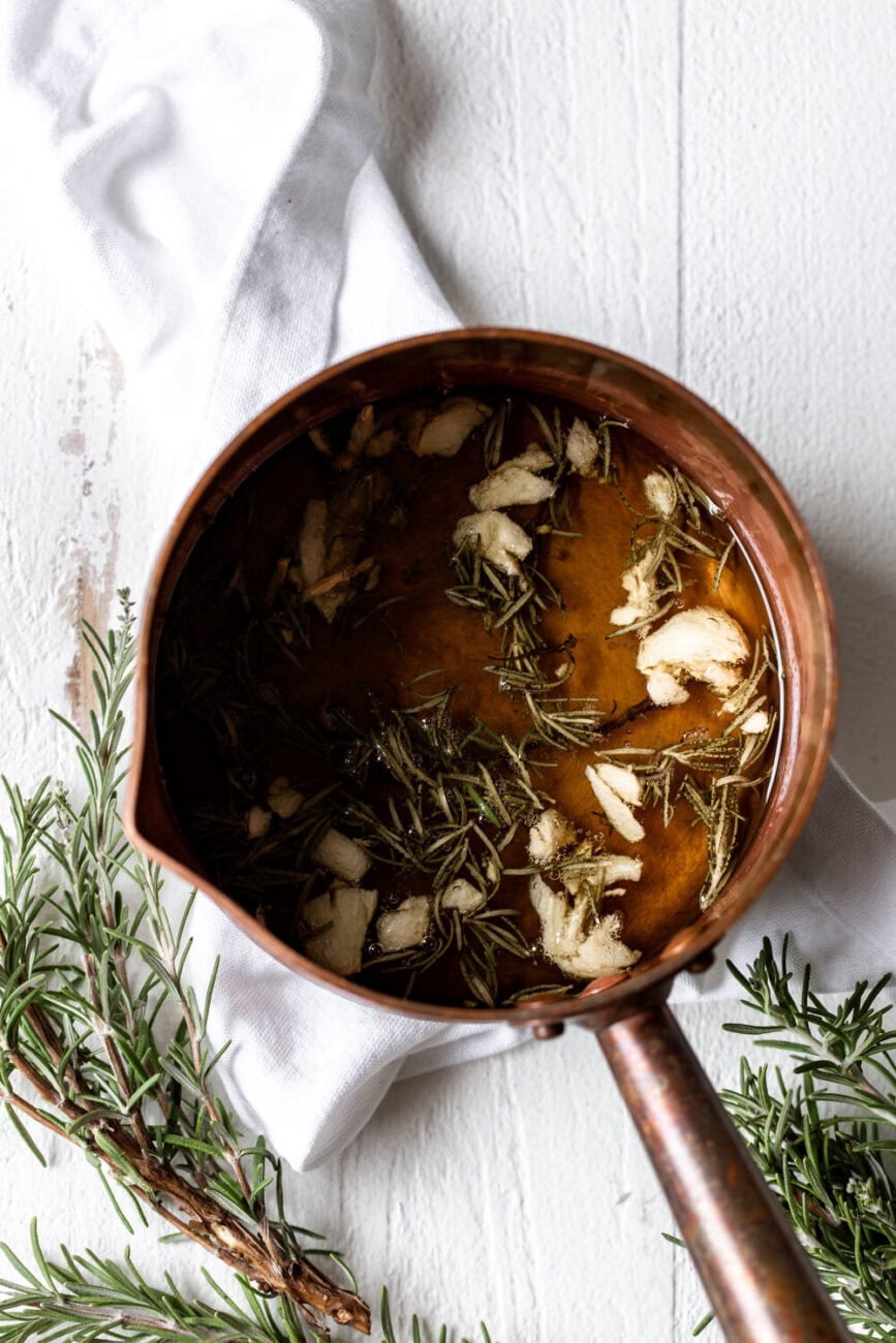 simmered garlic and rosemary in small copper pot.