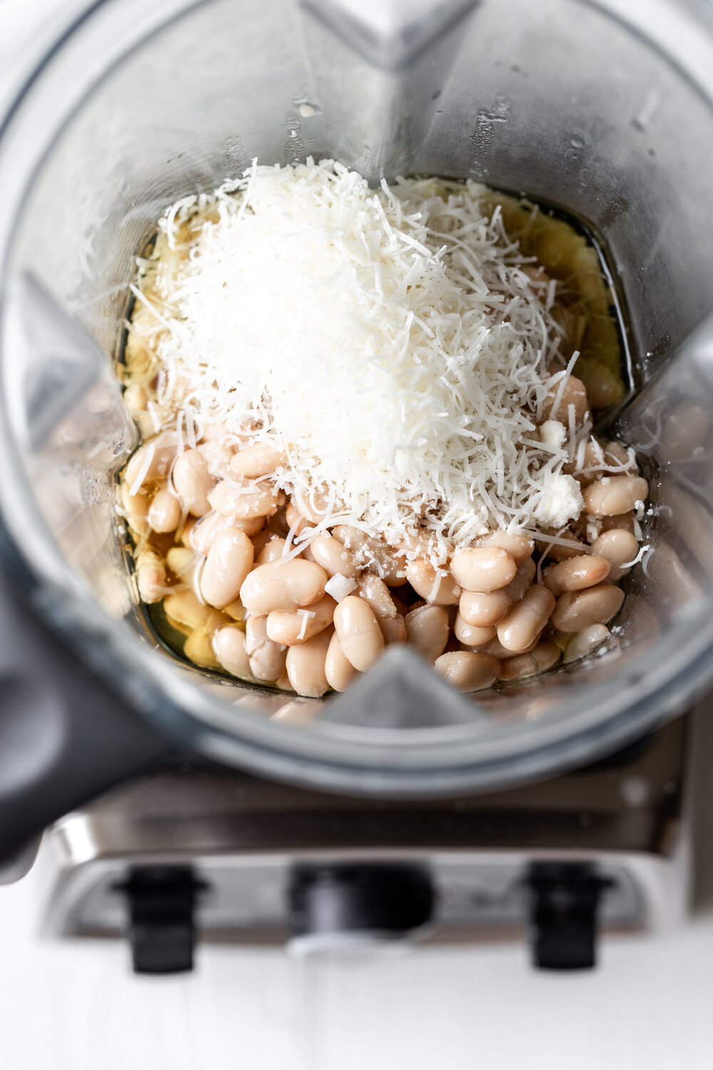 white beans with garlic infused oil and cheese in blender