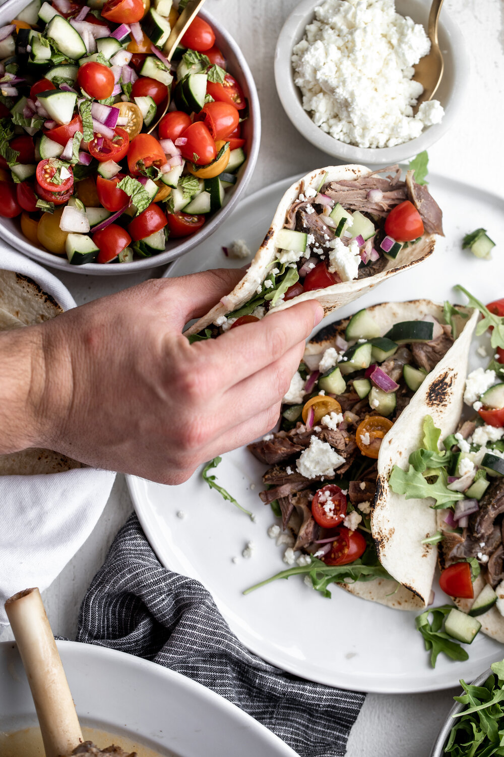 Shawarma-Spiced Roast Pulled Lamb Leg Tacos with hand 