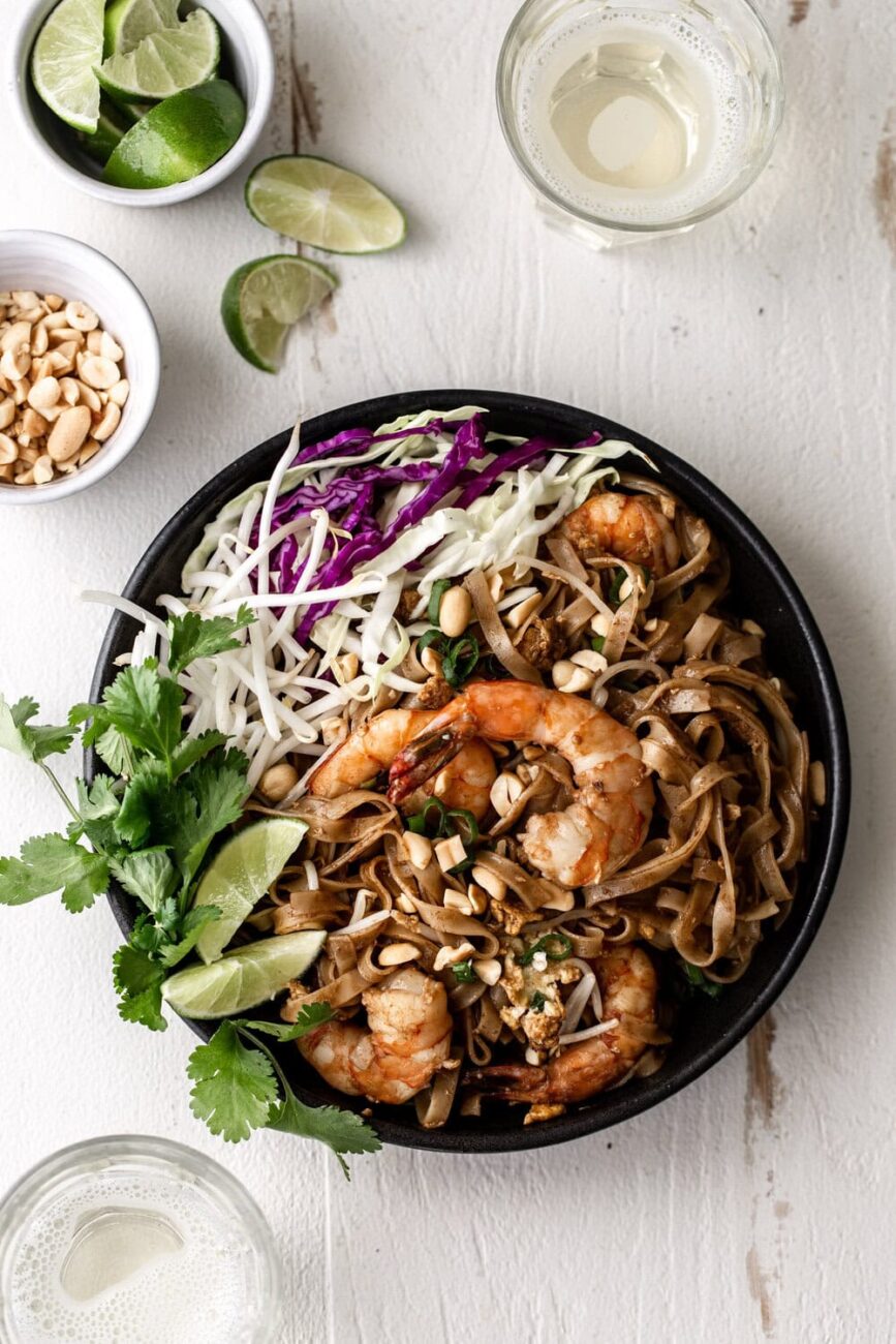 Pad Thai with Shrimp with green and purple cabbage with lime.
