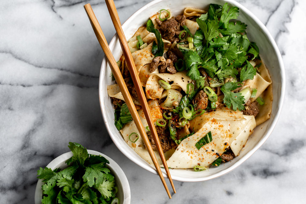Sichuan-Style Spicy Cumin Lamb Noodles overhead photo with cilantro and green onion