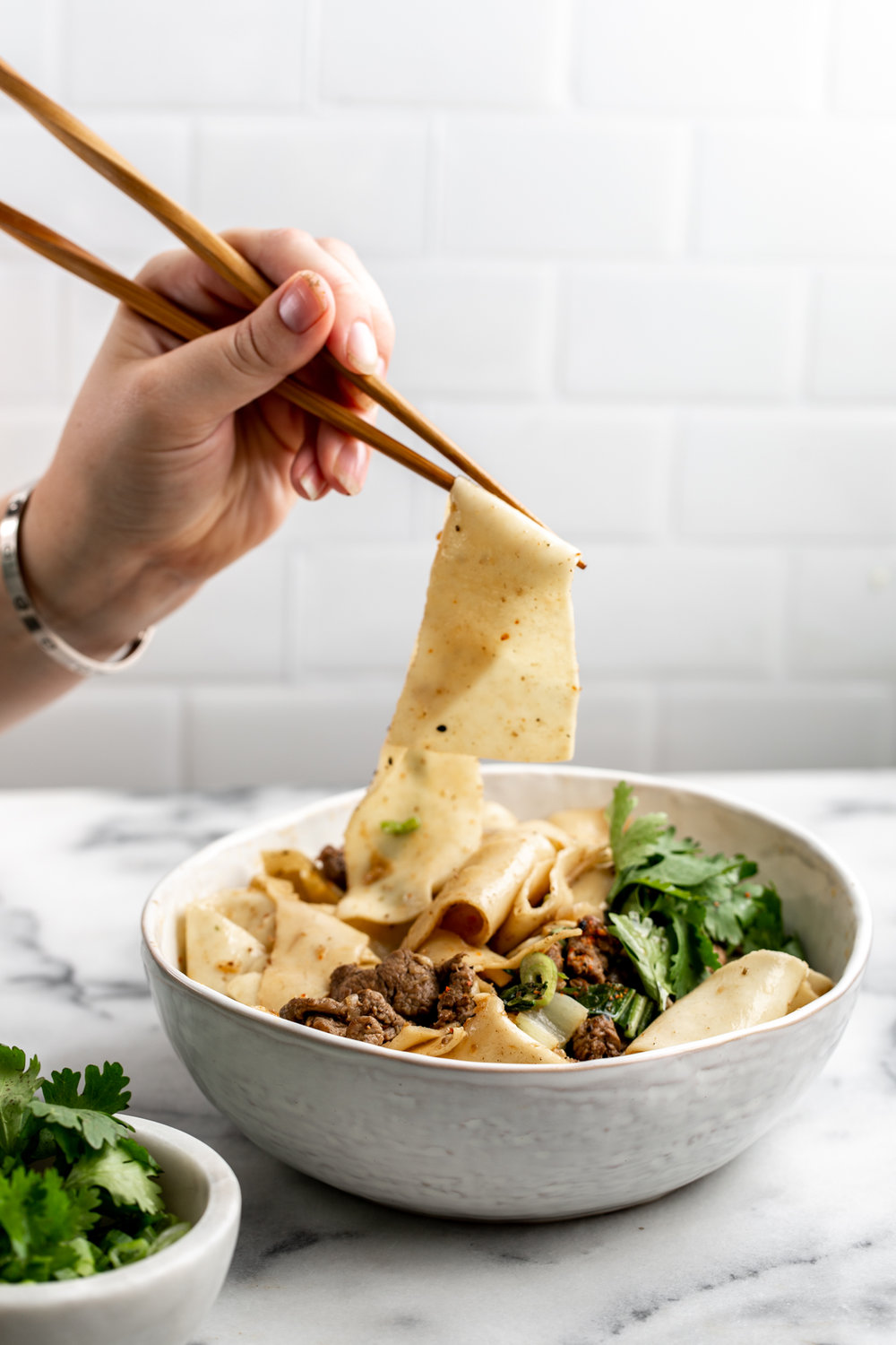 Sichuan-Style Spicy Cumin Lamb Noodles in white serving bowl