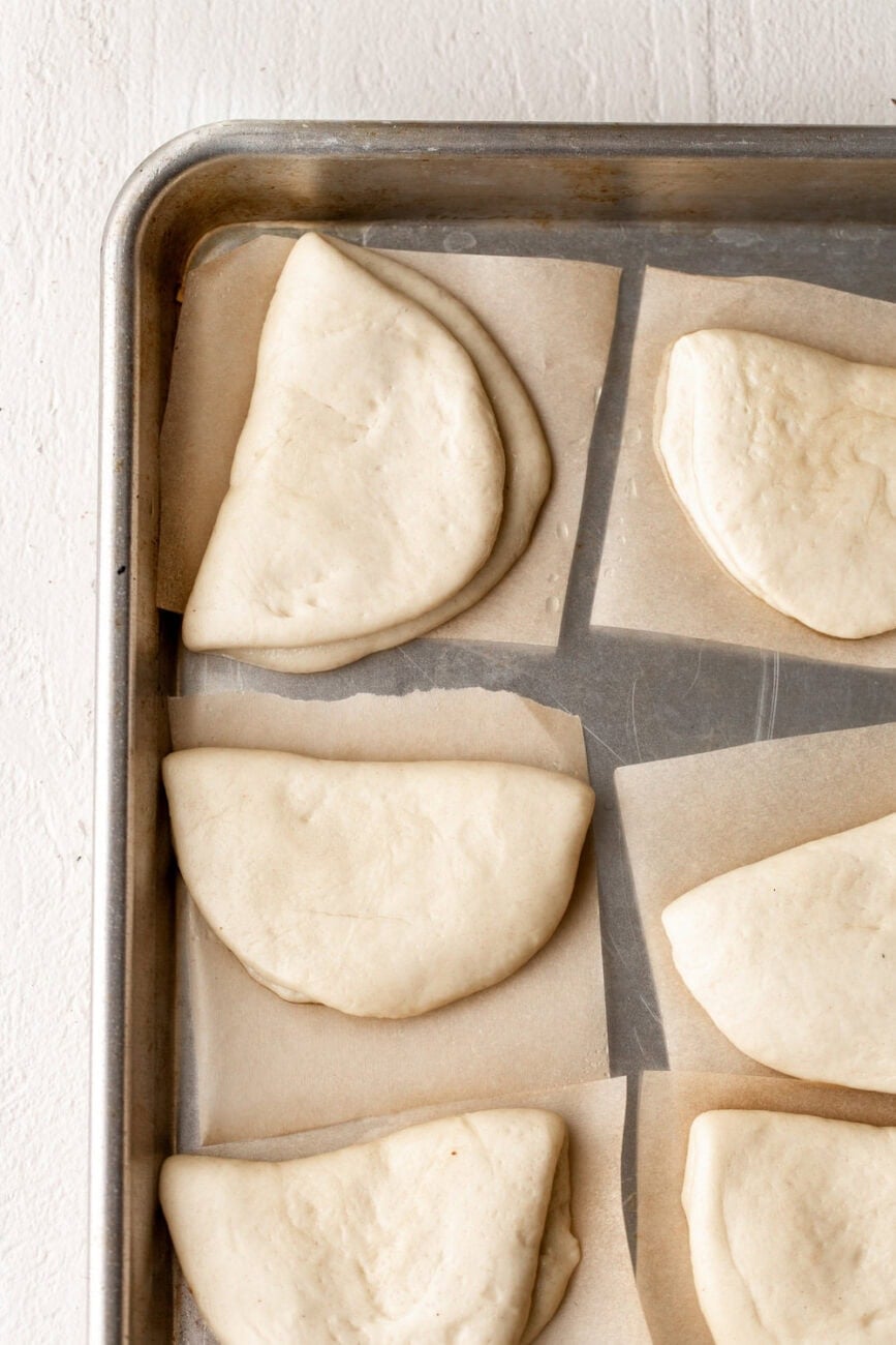 Divided dough for bao buns shaped and folded.