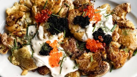 smashed fried potatoes with herbs caviar and creme fraiche.