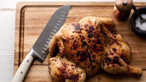 lemon garlic spatchcocked chicken on cutting board