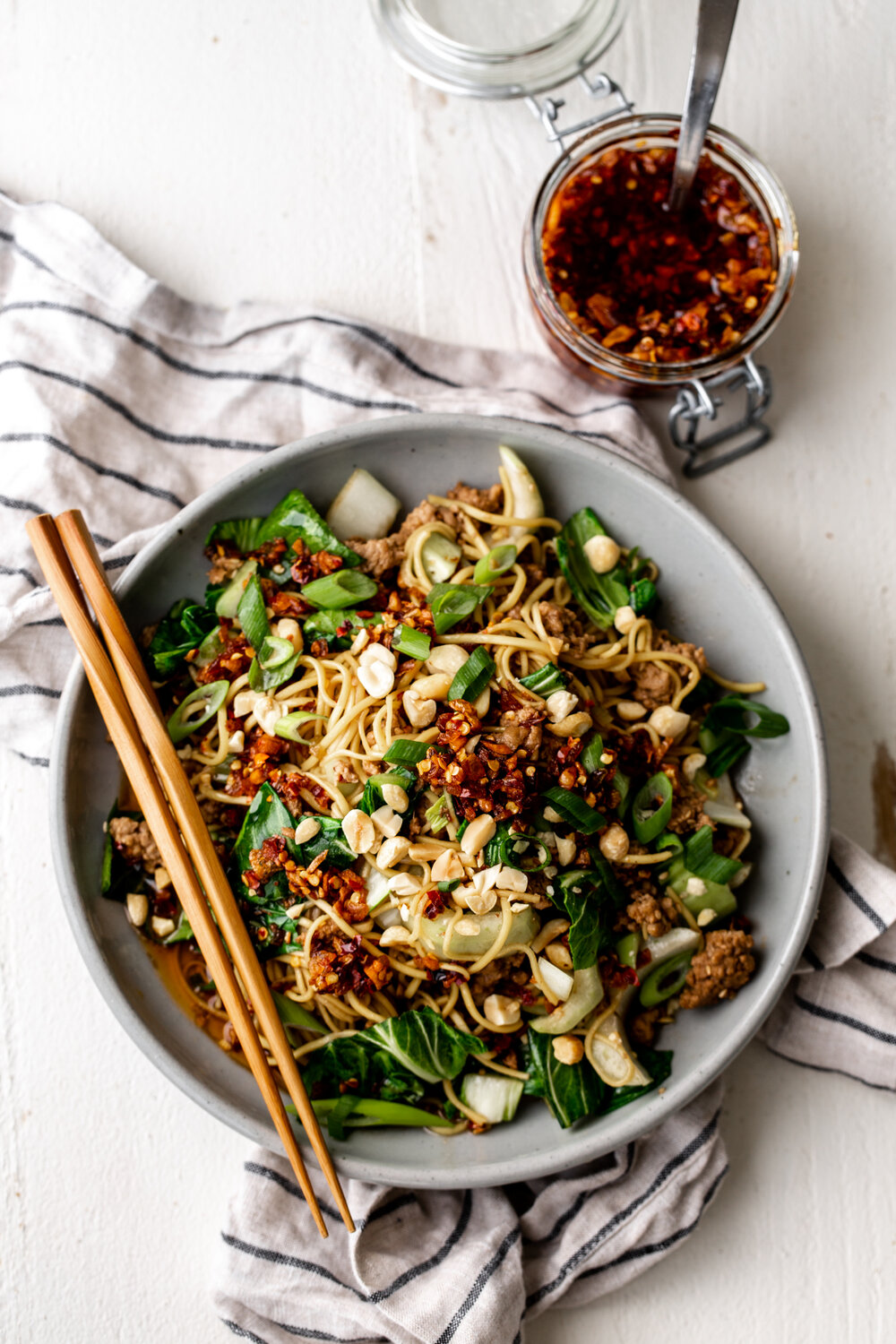 Spicy Dan Dan Noodles with Bok Choy & Crunchy Chili Oil and chopsticks